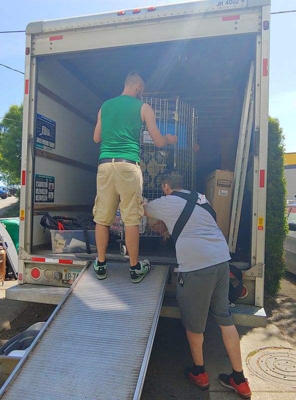Ryan and James loading a box truck in 2018